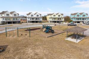 a playground in a yard with houses in the background at 7767 - Swordfish in Buxton