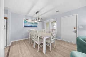 a dining room with a white table and chairs at 7767 - Swordfish in Buxton