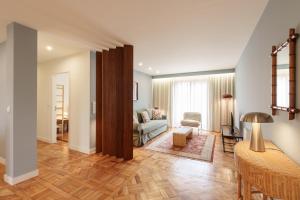 a living room with a couch and a table at VIVA Serpa Pinto Serviced Apartments in Porto