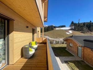 a balcony with two couches on a house at Ferienwohnungen Unterdürmoos Apartments mit Chalet-Charme auf 1050 m , Alleinlage in Annaberg im Lammertal