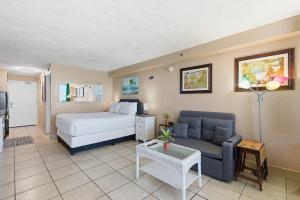 a hotel room with a bed and a couch at Daytona Harbour Beach Resort Unit 808 in Daytona Beach