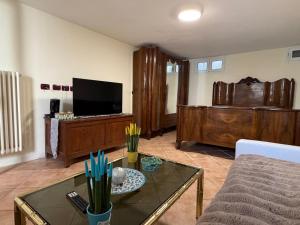 a living room with a couch and a tv at Arma central Garden in Arma di Taggia