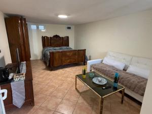 a living room with a couch and a bed at Arma central Garden in Arma di Taggia