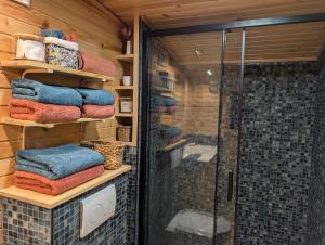 a shower room with towels and a glass shower stall at Roulotte Gîtes O bien-être massage Spa Séjour bien-être en hébergement insolite roulotte Karantez ou en gîtes Melon ou Yock à 800 m des plages in Porspoder +101 photos