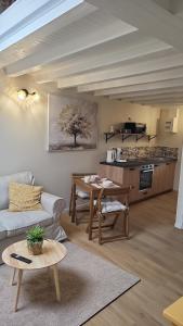 a living room with a couch and a table at Les 3 Nuances in Saint-Suliac