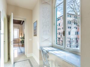 a hallway with a window and a glass bench at Noble Floor - Panoramic Luxury Apartment in Lucca
