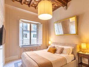 a bedroom with a large bed and a window at Noble Floor - Panoramic Luxury Apartment in Lucca