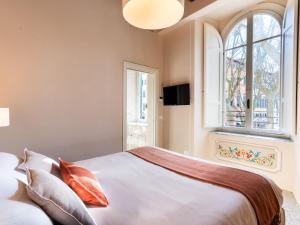 a bedroom with a large bed and a window at Noble Floor - Panoramic Luxury Apartment in Lucca