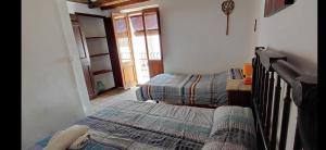 a bedroom with two twin beds and a window at Can Manuel in Gabet
