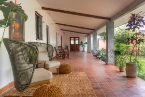 a living room with chairs and a porch at Hotel Alto Monte Hacienda & Spa - Only Adults in Chiguirí Arriba