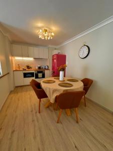 a kitchen with a table and chairs and a red refrigerator at Ocean Breeze in Perth