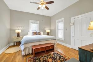 a bedroom with a bed and a ceiling fan at Austin Haus in Fredericksburg