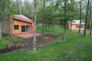 a small wooden cabin in the middle of a forest at Architectural Cabin 18 mins to Catamount in Taghkanic