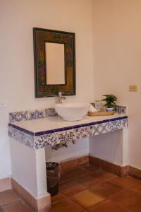 a bathroom with a sink and a mirror on a counter at Posada Santa Isabel in Parras de la Fuente +23 photos