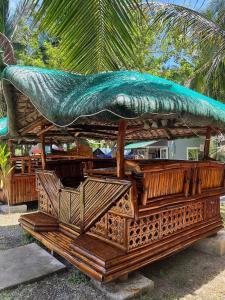 a gazebo with a green roof on top of it at Starksway Resort in San Juan