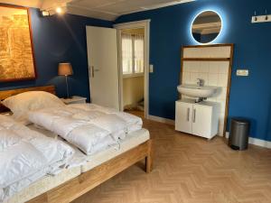 a bedroom with a large bed and a sink at Ferienhaus Nicklas in Bad Schandau