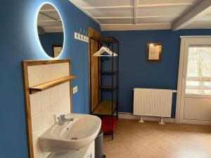 a bathroom with a sink and a mirror at Ferienhaus Nicklas in Bad Schandau