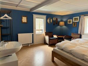 a blue bedroom with a bed and a sink at Ferienhaus Nicklas in Bad Schandau +5 photos