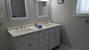 a bathroom with two sinks and two mirrors at Bear & Butterfly Bed and Breakfast in Gravenhurst +26 photos