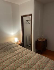 a bedroom with a bed and a dresser and a mirror at Casa do Fundão in Paredes +19 photos