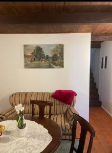 a living room with a couch and a table at Casa do Fundão in Paredes