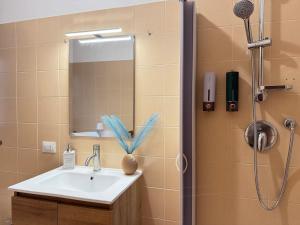 a bathroom with a sink and a shower at Casa Azul - Social Apartment - parcheggio, clima, 200mt dal mare in Scoglitti +31 photos