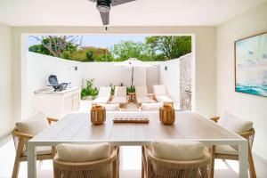 a dining room with a table and chairs at New Stylish 2BR Villa Walk to Beach Pool in Saint James