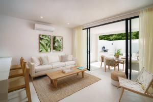 a living room with a couch and a table at New Stylish 2BR Villa Walk to Beach Pool in Saint James +8 photos