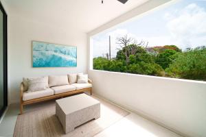 a living room with a couch and a large window at New Stylish 2BR Villa Walk to Beach Pool in Saint James