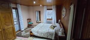 a bedroom with a bed in a room with windows at Casa della Mamma in Antey-Saint-André