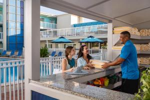 a group of people standing at a counter on a balcony at Bilmar Beach Resort in St. Pete Beach +85 photos