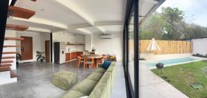 an open living room with a couch and a table at Jungle surf Villa in El Zonte