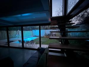 a house with a view of a swimming pool at night at Jungle surf Villa in El Zonte
