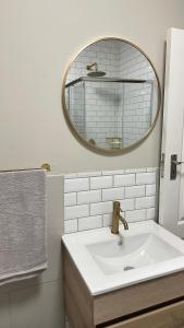 a bathroom with a sink and a mirror at De Guest Suites in Eversdal +41 photos