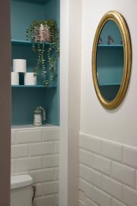 a bathroom with a mirror and a white toilet at La maison du bienvenu in Namur +40 photos