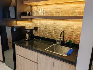 a kitchen counter with a sink and a refrigerator at STREET MALL Luna N6-3 in Puebla +7 photos