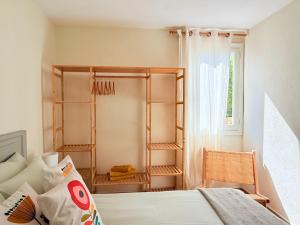 a bedroom with a bed and a room with shelves at Casa Maya by GMHouse Menorca in Cala Blanca