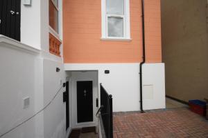 a hallway of a building with a door and a window at Osterley Place - Apt F in Hounslow