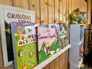 a shelf with childrens books on it at Tiny House at Sedliacky Dvor - Brezno in Brezno +17 photos