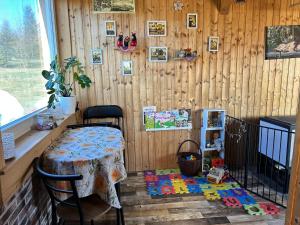 a room with a table and a wooden wall at Tiny House at Sedliacky Dvor - Brezno in Brezno
