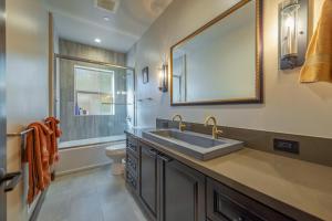 a bathroom with a sink and a toilet and a mirror at 4BR Home w/ 2 Decks, Near Lake & Ski Resorts in Truckee +13 photos