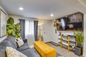 a living room with a couch and a flat screen tv at Work & Explore Downtown Tacoma! Convenient Condo in Tacoma