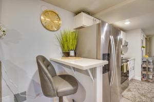 a kitchen with a counter and a chair and a clock at Work & Explore Downtown Tacoma! Convenient Condo in Tacoma