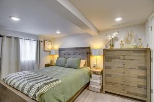 a bedroom with a large bed and a dresser at Work & Explore Downtown Tacoma! Convenient Condo in Tacoma