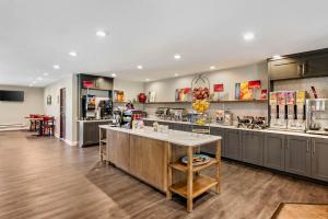 a large kitchen with a counter in the middle at Best Western Plus Eagle Vail Airport in Eagle