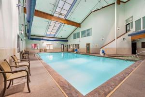 a large swimming pool in a building with chairs at Best Western Plus Eagle Vail Airport in Eagle
