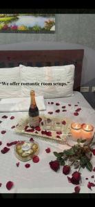 a bed with roses and candles and a table with candles at Starksway Resort in San Juan +7 photos