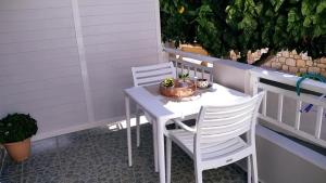 a white table and chairs on a patio at Mulberry house in Elafonisos