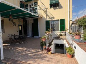 a patio of a house with potted plants and a table at Arma central Garden in Arma di Taggia