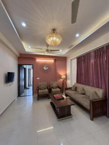 a living room with a couch and a table at The Huddle - Dawn in Dehradun